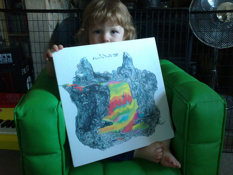 cover of Acid Birds LP III on Blackest Rainbow held by Otis